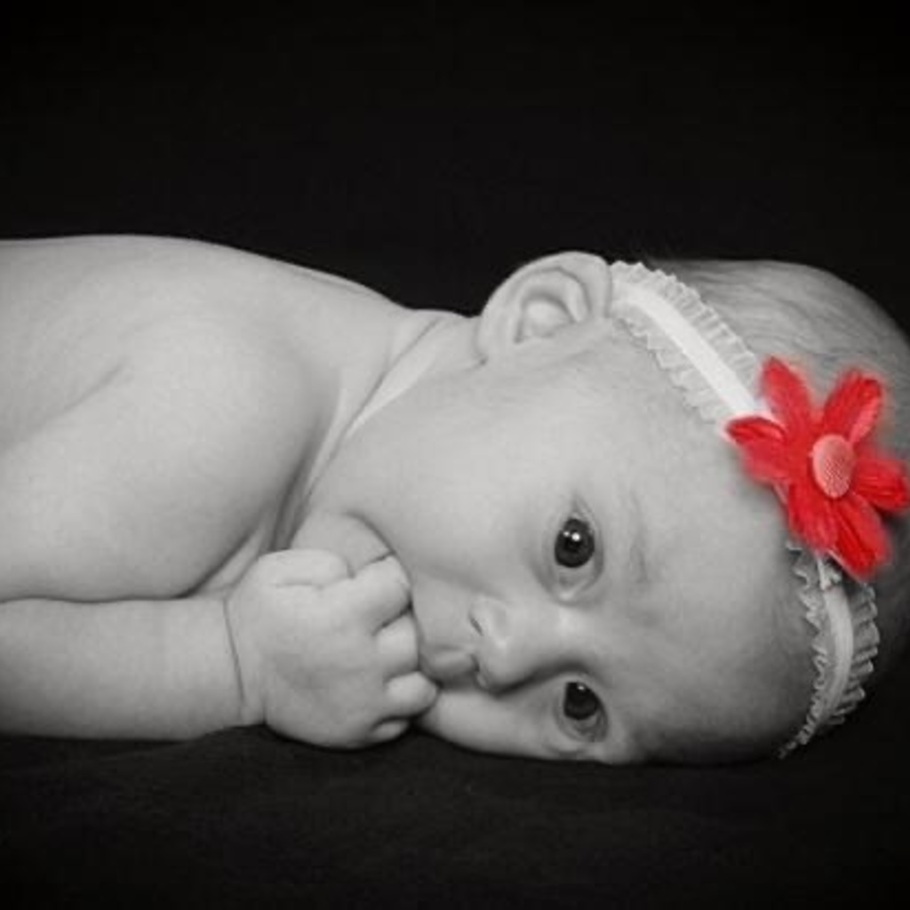 Newborn baby in black & white with flower