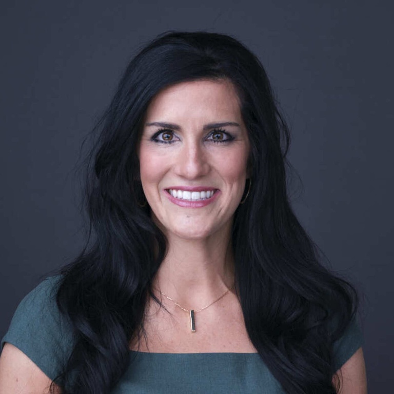 Photo of female with long dark hair, bright eyes