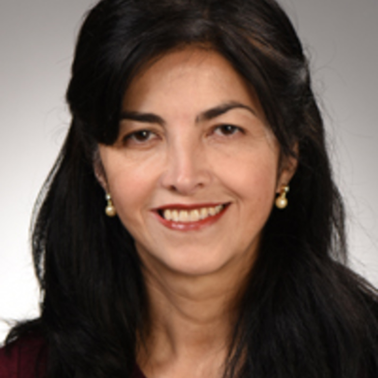 Brunette woman with long hair wearing a black blazer