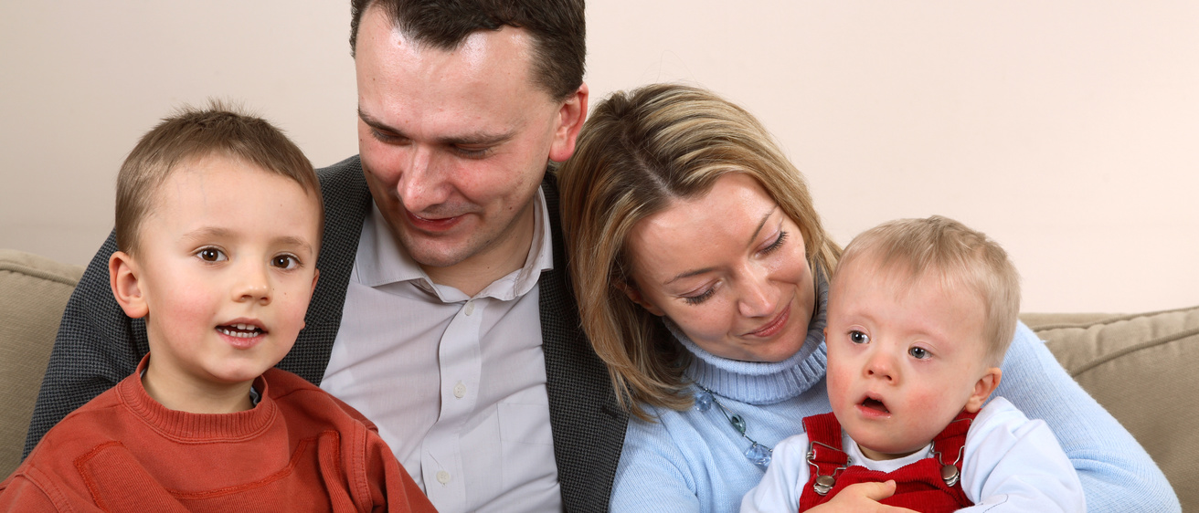 Photo of young family with child with Down Syndrome