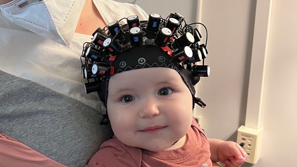 Photo of baby wearing fNIRS cap